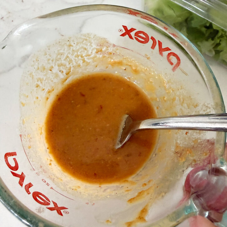 Finished peanut sauce in a measuring cup.