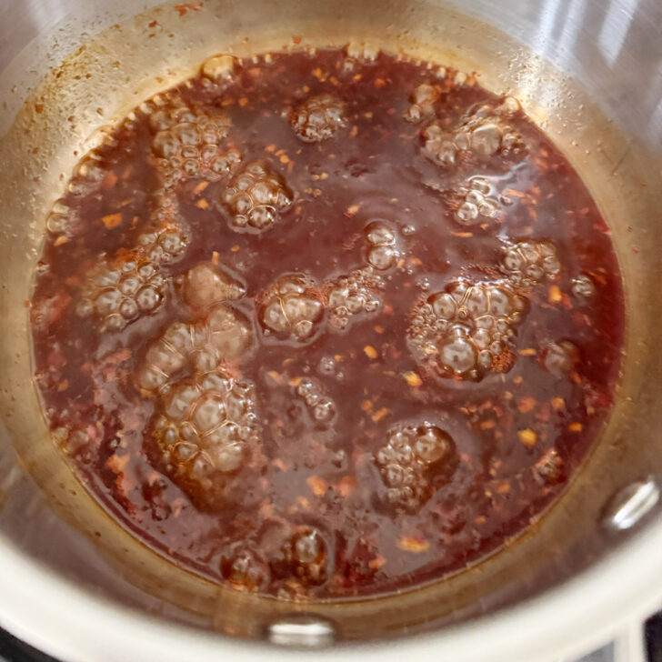 Cooking the hot honey sauce in a saucepan.