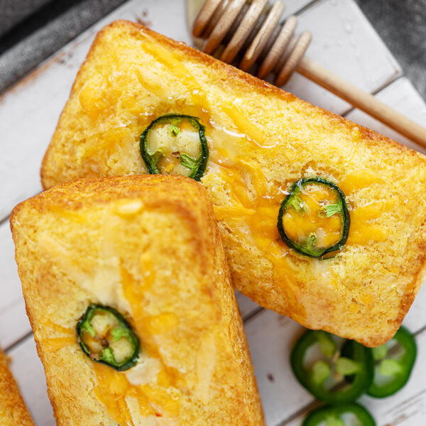Mini cornbread loaves on a serving board.