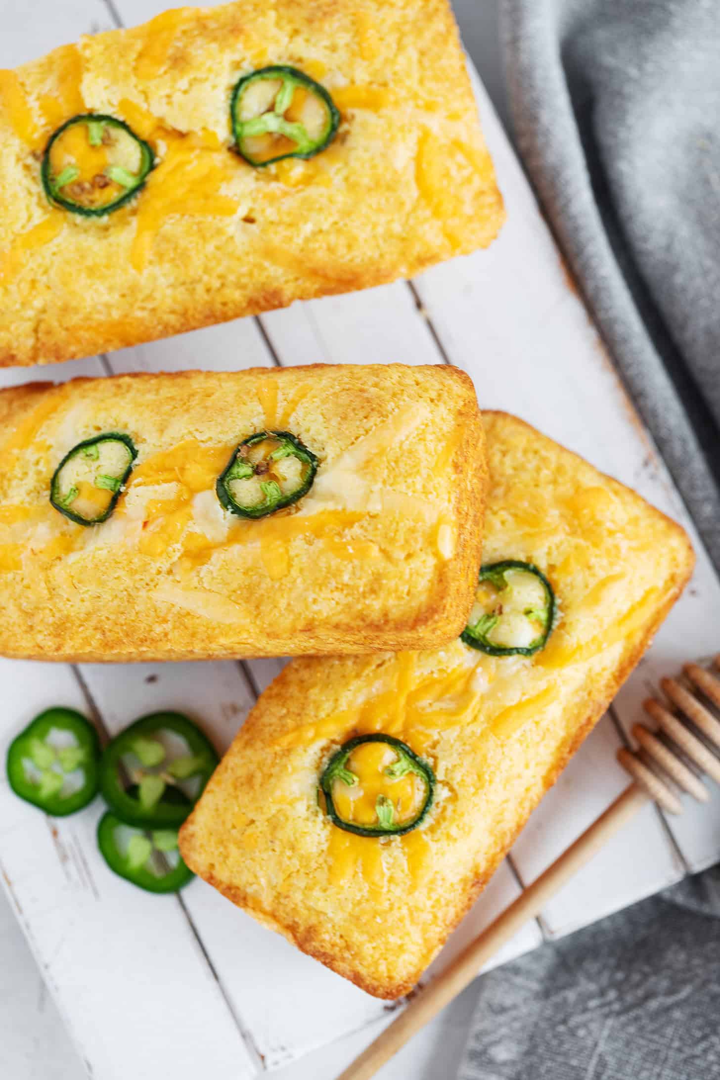 Mini cornbread loaves on a serving board.