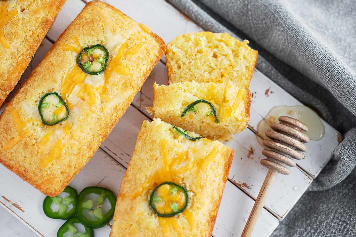 Mini cornbread loaves on a serving board.