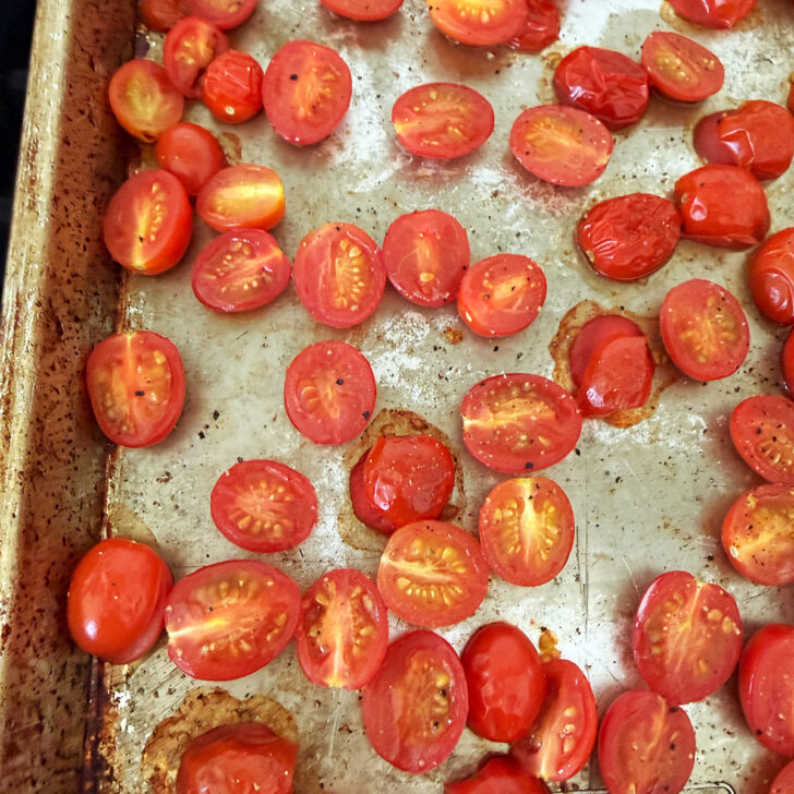 Oven-roasted cherry tomatoes on a baking sheet.