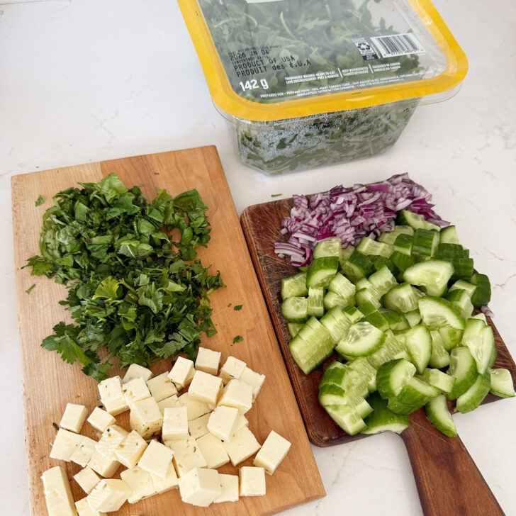 Vegetables, herbs, halloumi and arugula prepared.