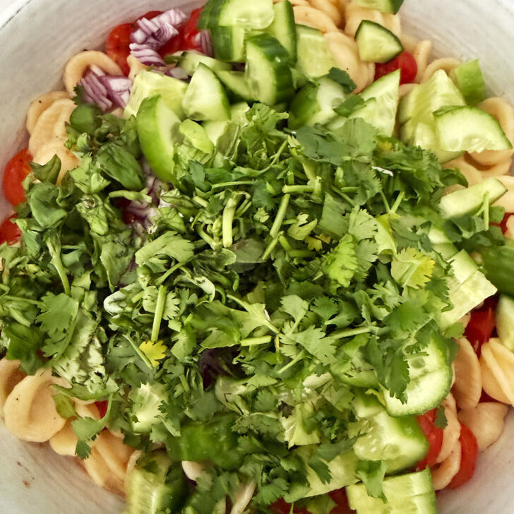 Vegetables and herbs added to the pasta and roasted tomatoes.