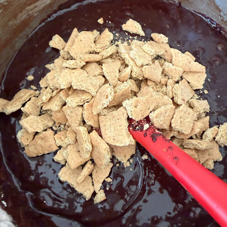 Adding crumbled graham crackers to the brownie batter.