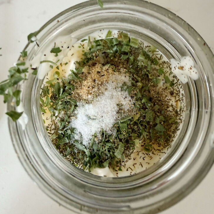 Buttermilk dressing ingredients in a glass jar.