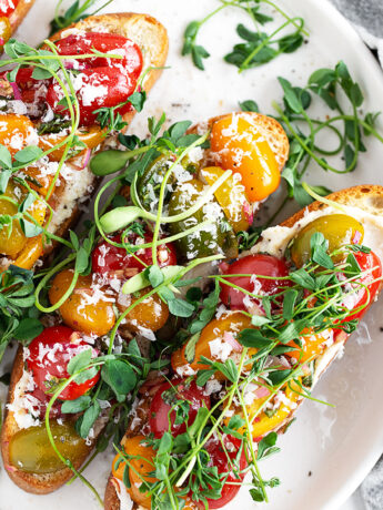 Cherry tomato bruschetta on a serving plate.