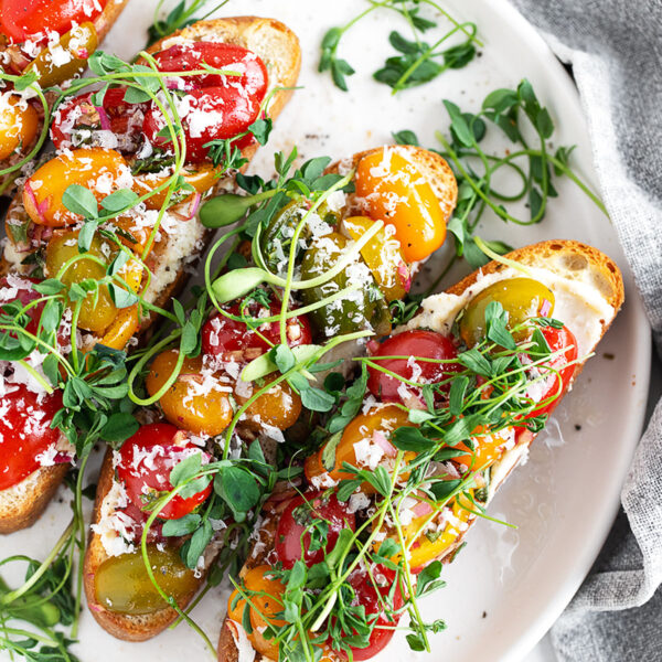 Cherry tomato bruschetta on a serving plate.