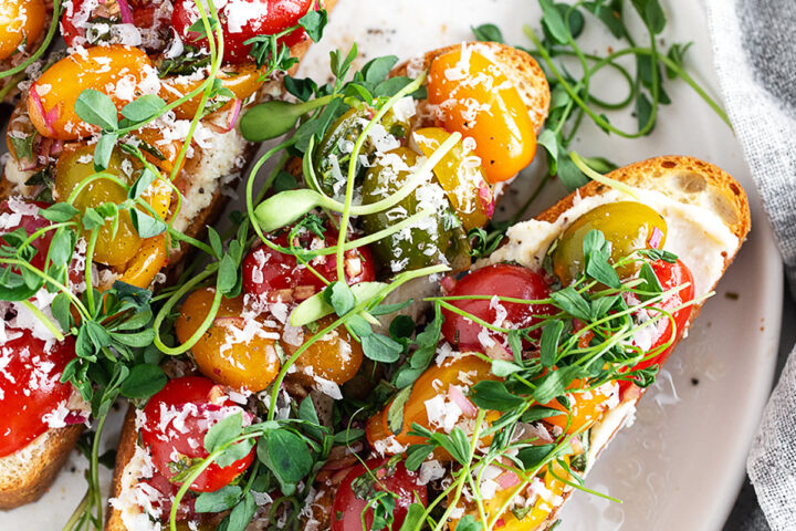 Cherry tomato bruschetta on a serving plate.