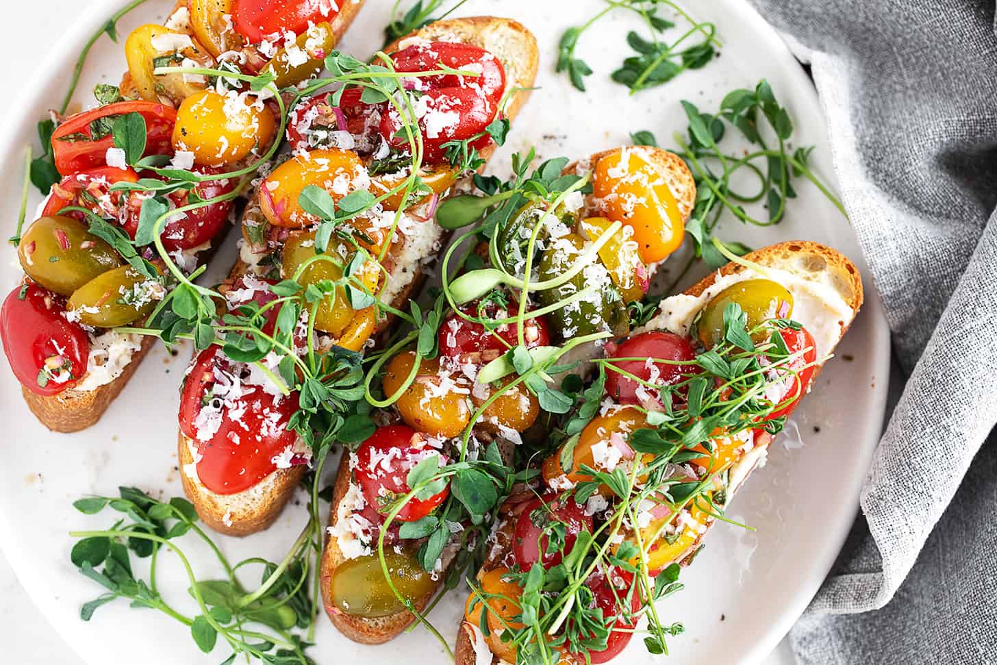 Cherry tomato bruschetta on a serving platter.