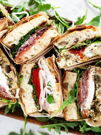 Focaccia sandwiches wrapped and displayed for serving.