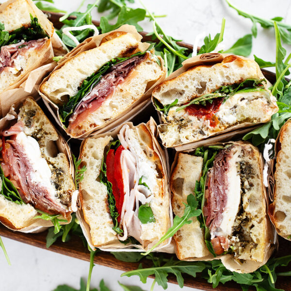 Focaccia sandwiches wrapped and displayed for serving.