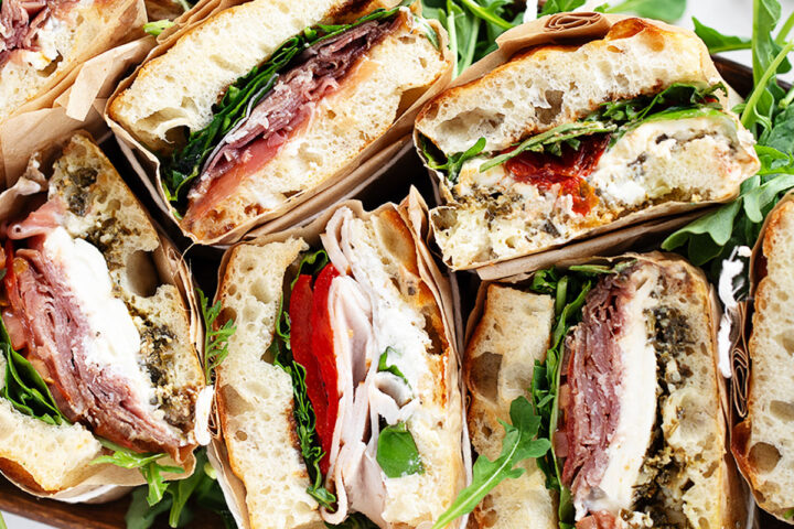 Focaccia sandwiches wrapped and displayed for serving.