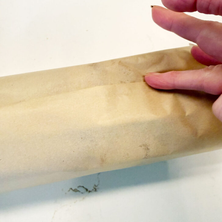 Fold the parchment paper down until flat.