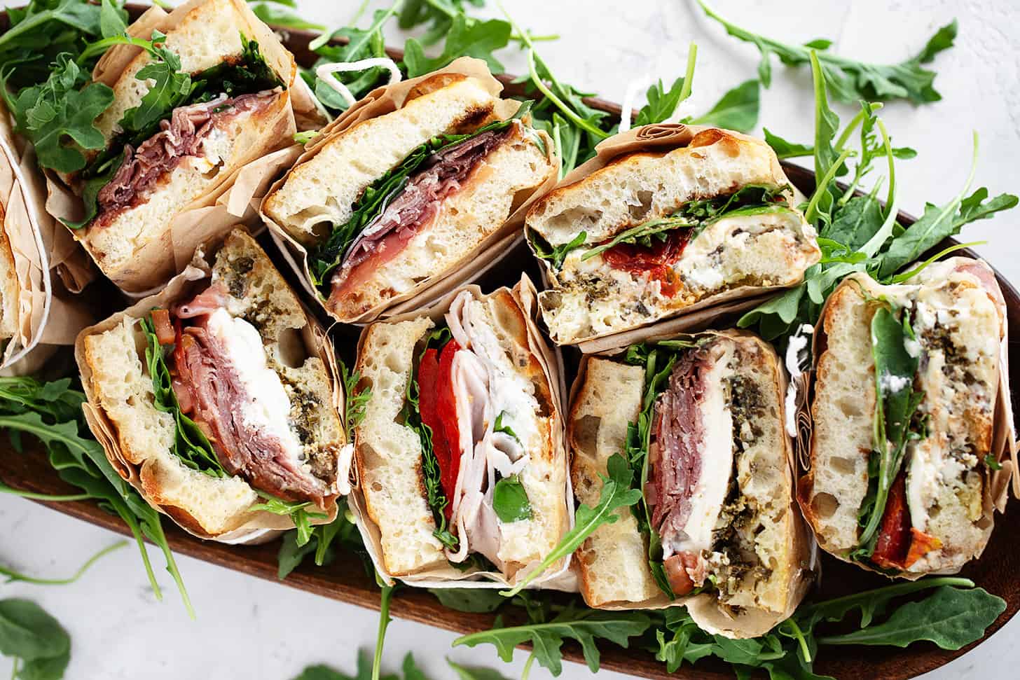 Focaccia sandwiches wrapped and displayed for serving.