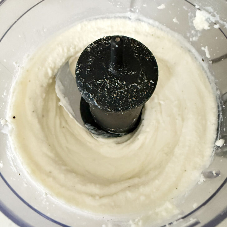 Whipping the ricotta cheese in a food processor.