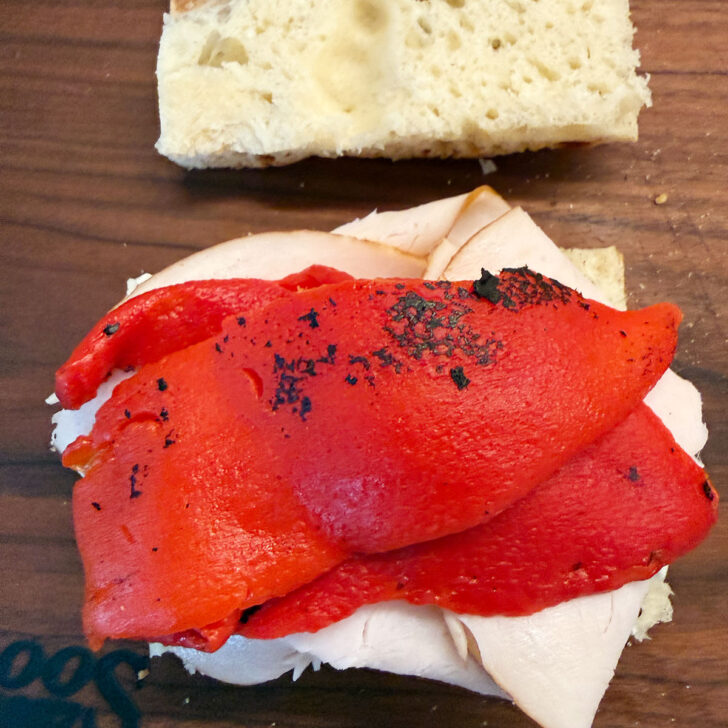Roasted red peppers on a focaccia sandwich.