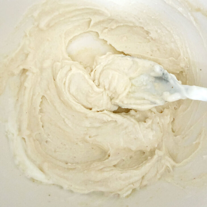 Tahini yogurt sauce for halloumi burgers mixed up in a bowl.