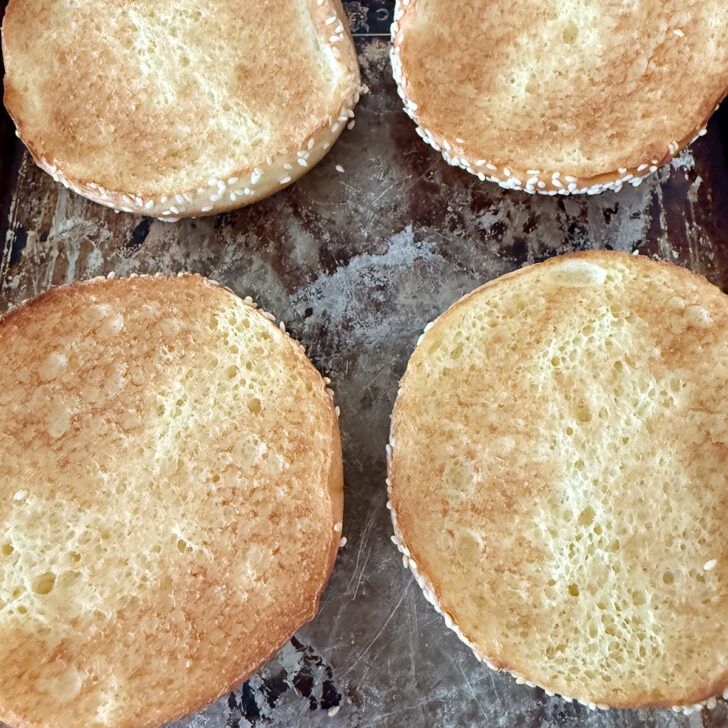 Toasted burger buns for halloumi burgers on a baking sheet.
