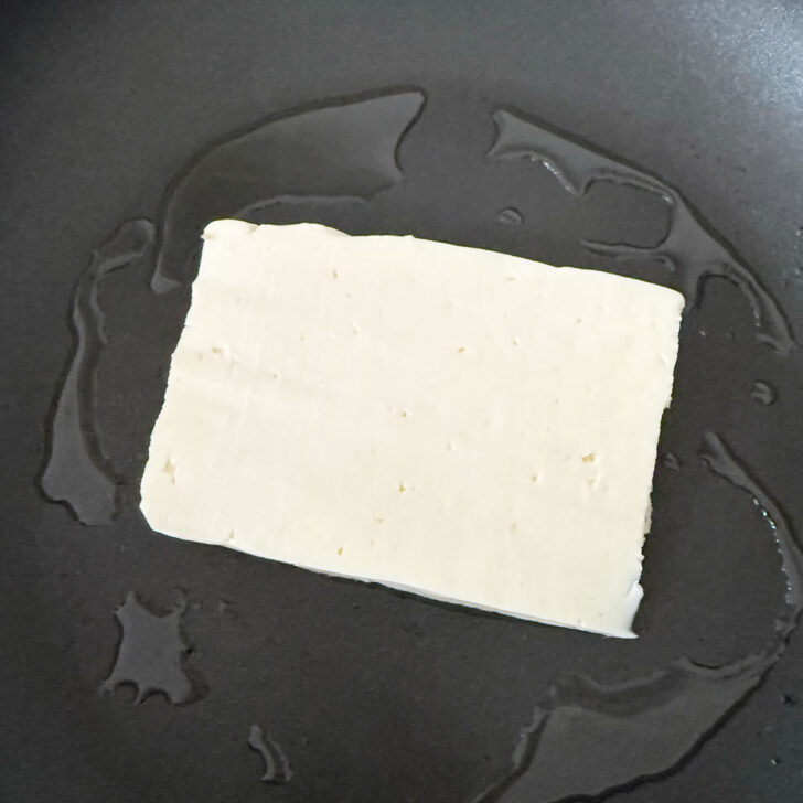 Halloumi placed into an oiled skillet.