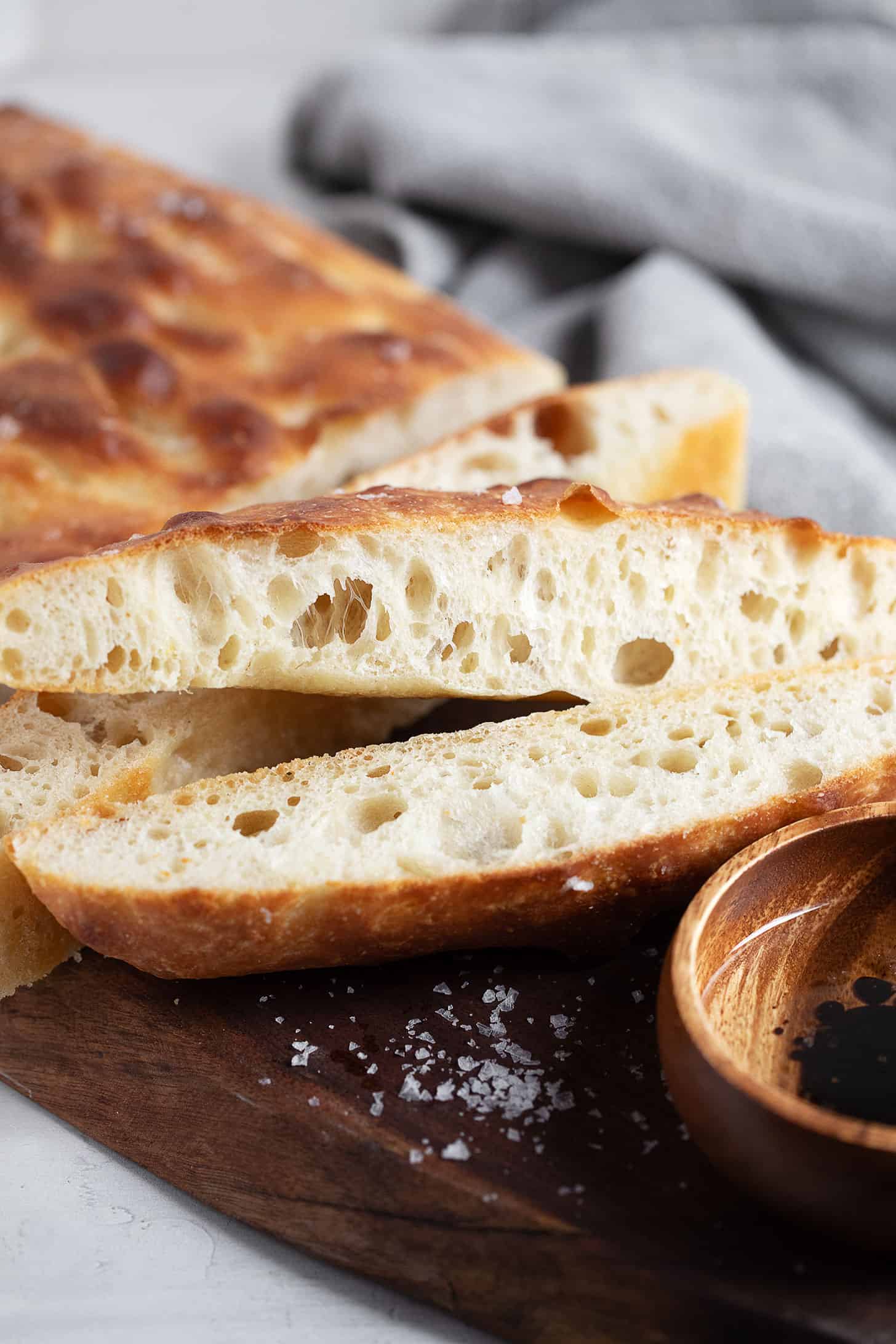 Overnight focaccia sliced on a cutting board.