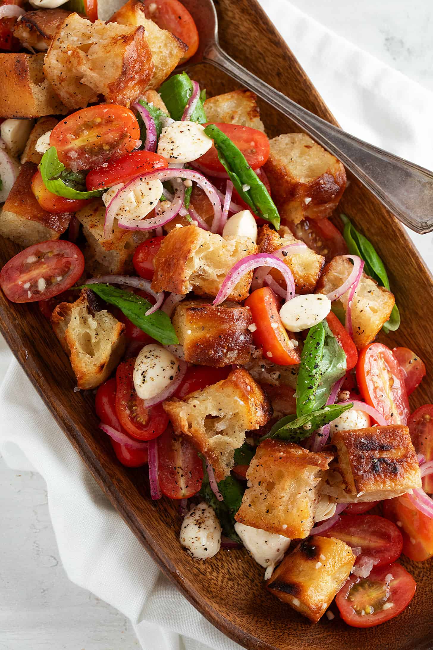 Focaccia panzanella salad in a wooden salad bowl.