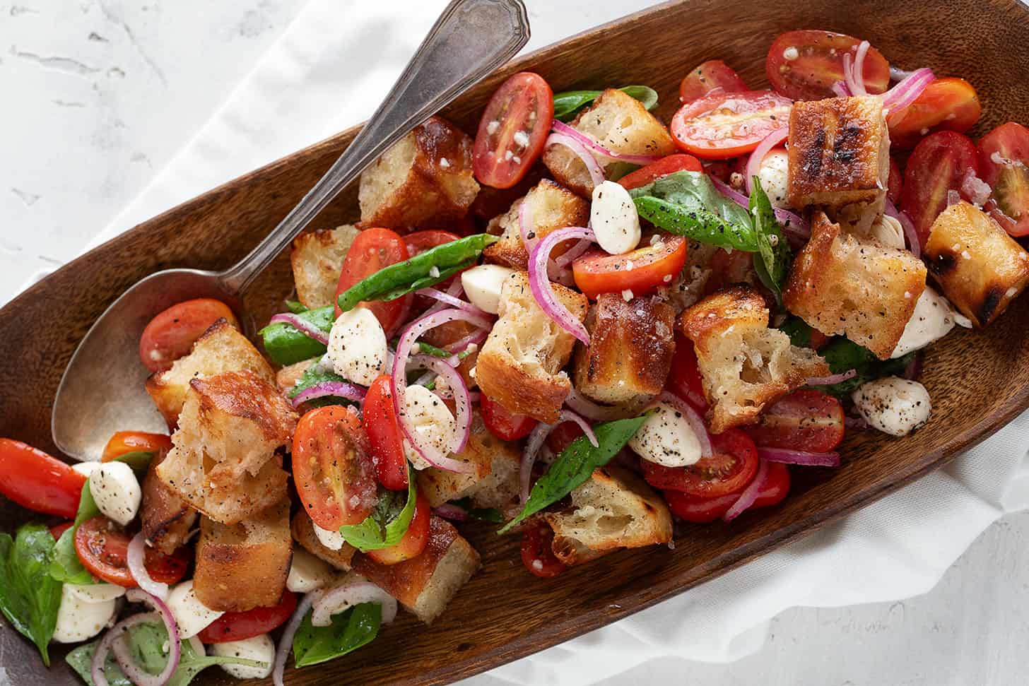 Focaccia panzanella in a wooden salad bowl.