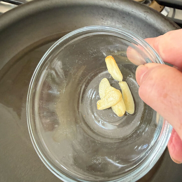 Removing the garlic from the oil.