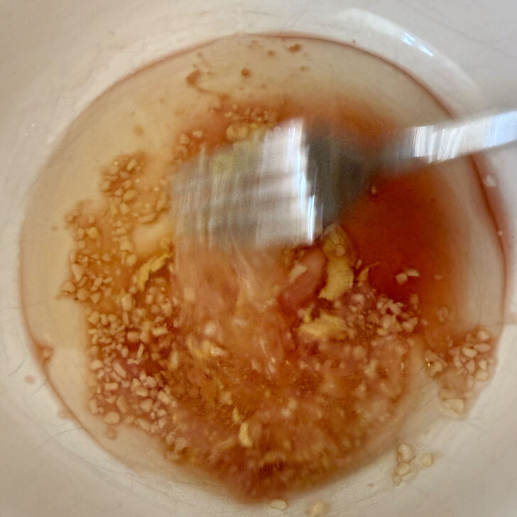 Mixing up the red wine vinaigrette in a small bowl.
