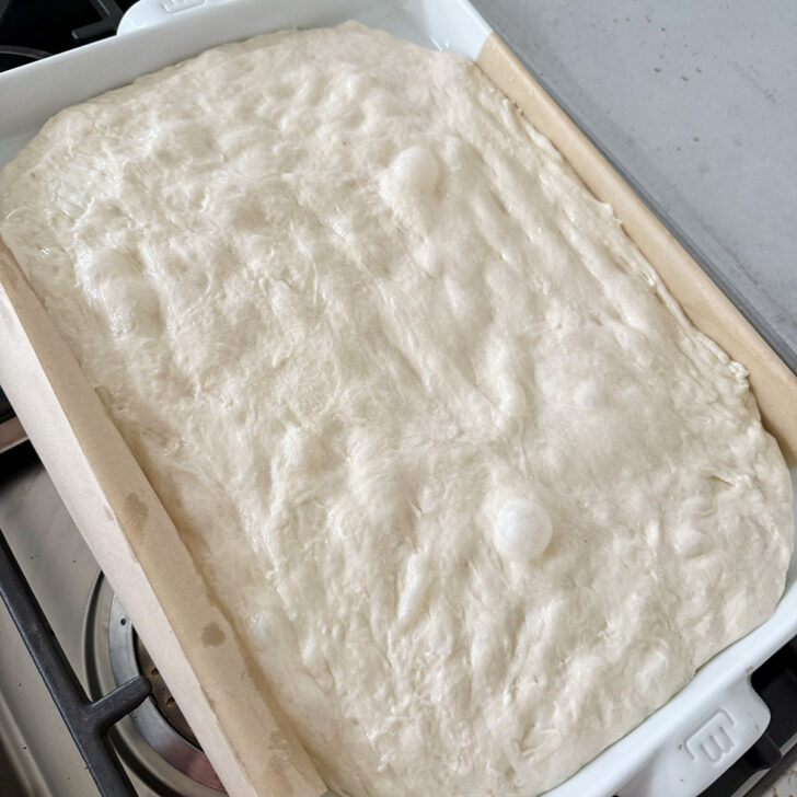 Focaccia dough after rising at room temperature.
