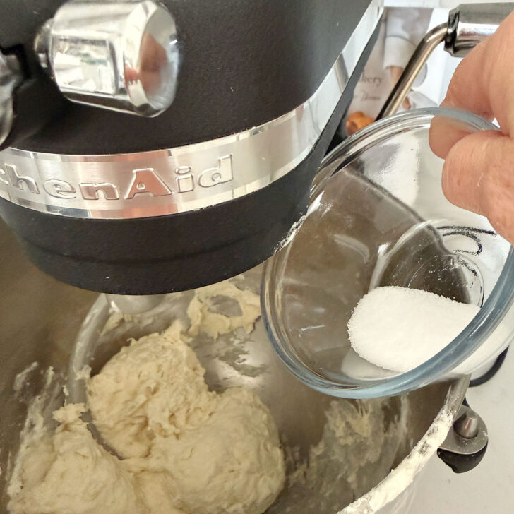 Adding the salt to the focaccia dough.