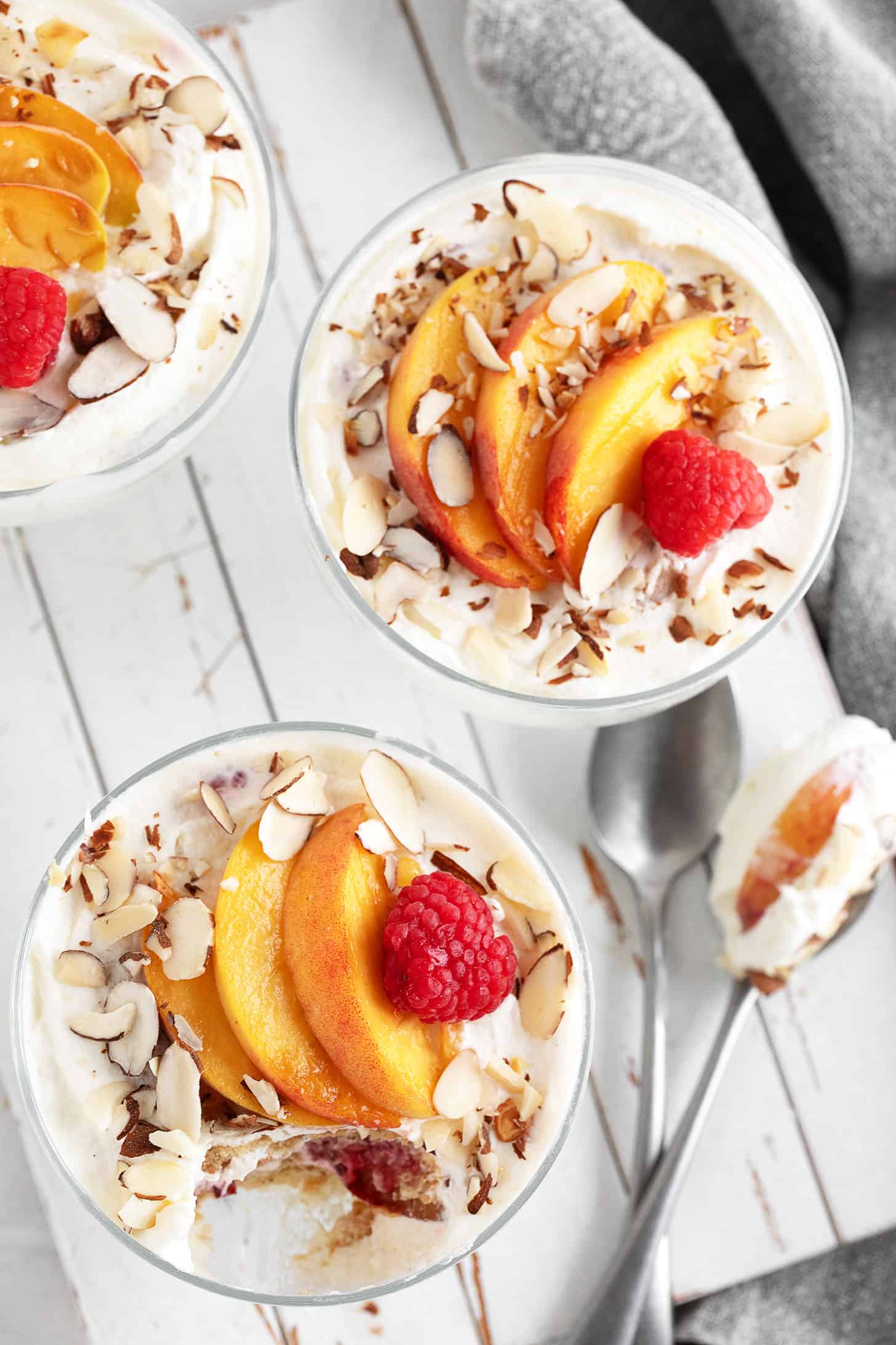 Creamy no-bake peach Melba dessert in serving cups.