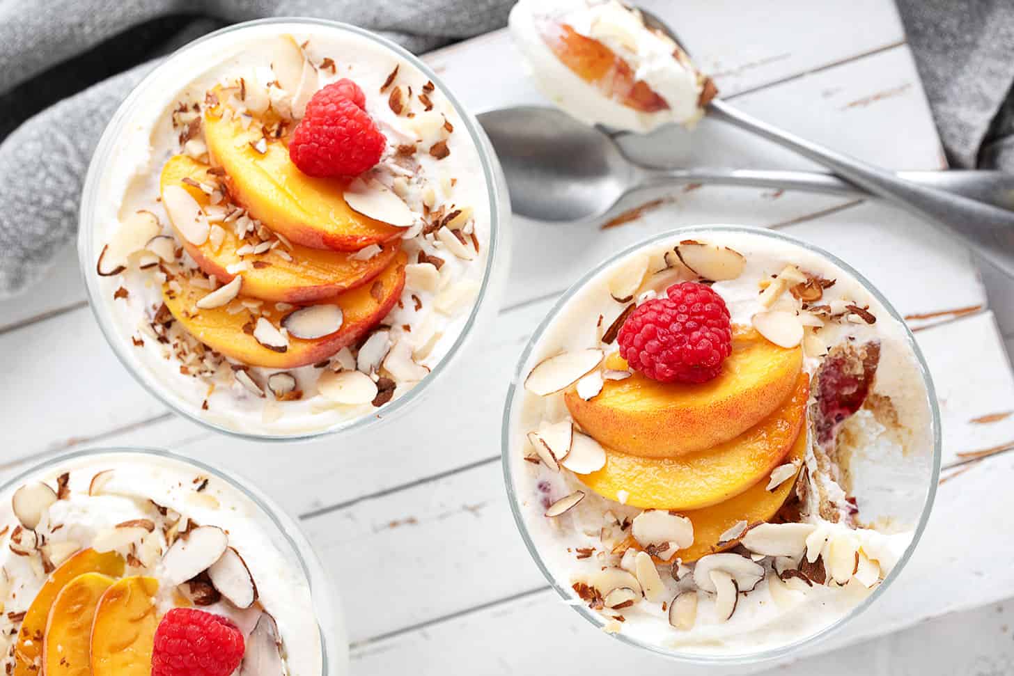 No-bake creamy peach melba dessert in individual serving cups.