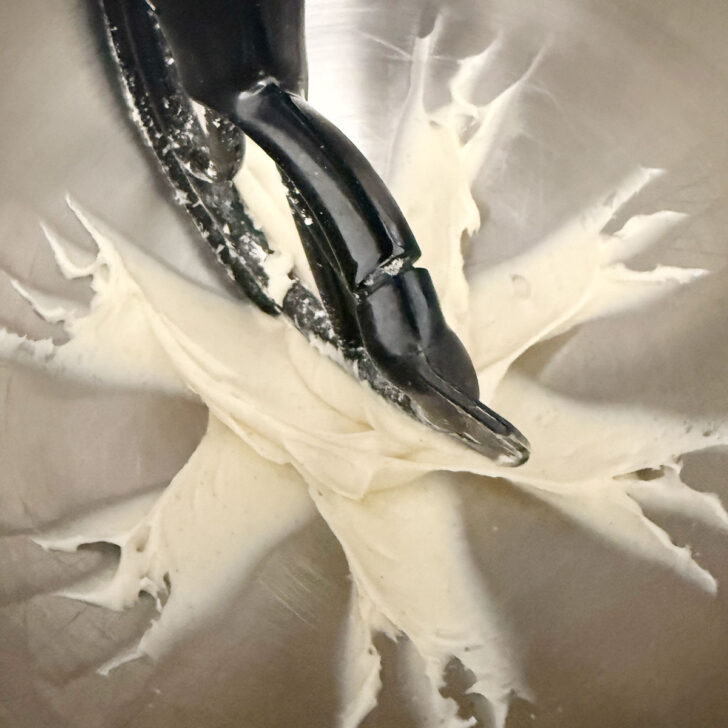 Whipping the cream cheese with the sugar and vanilla.