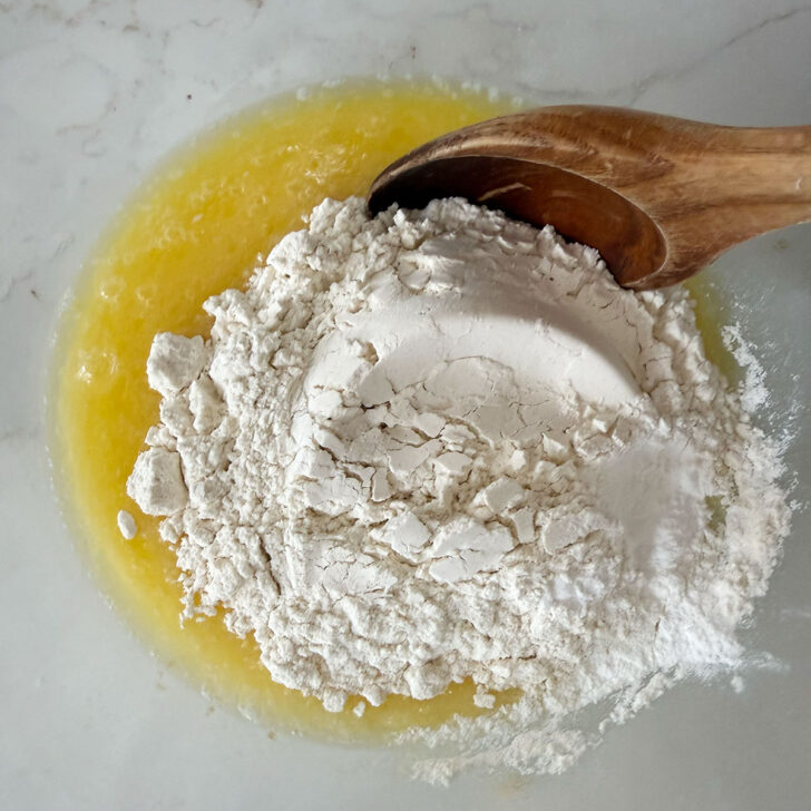 Adding floor, salt and baking powder to the melted butter and milk.