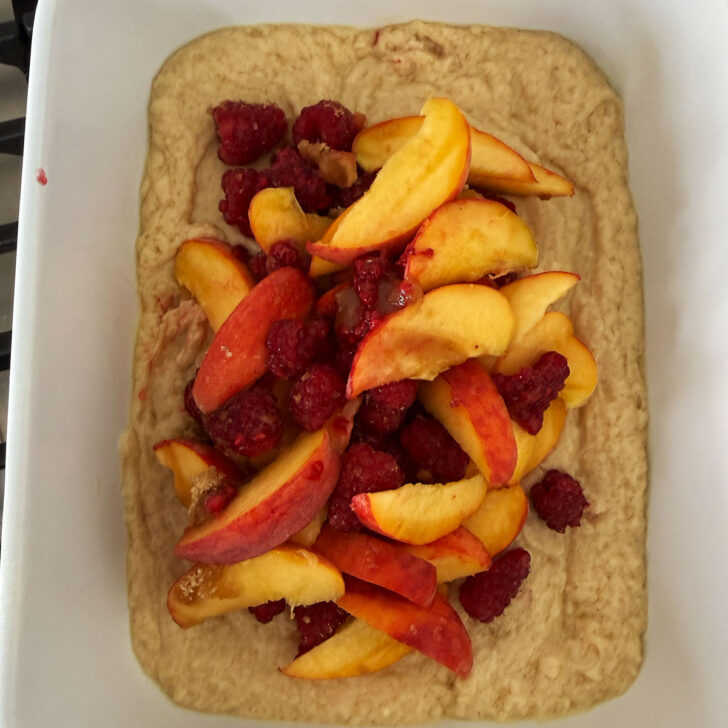 Peaches and raspberries spooned on the top of the cake batter.