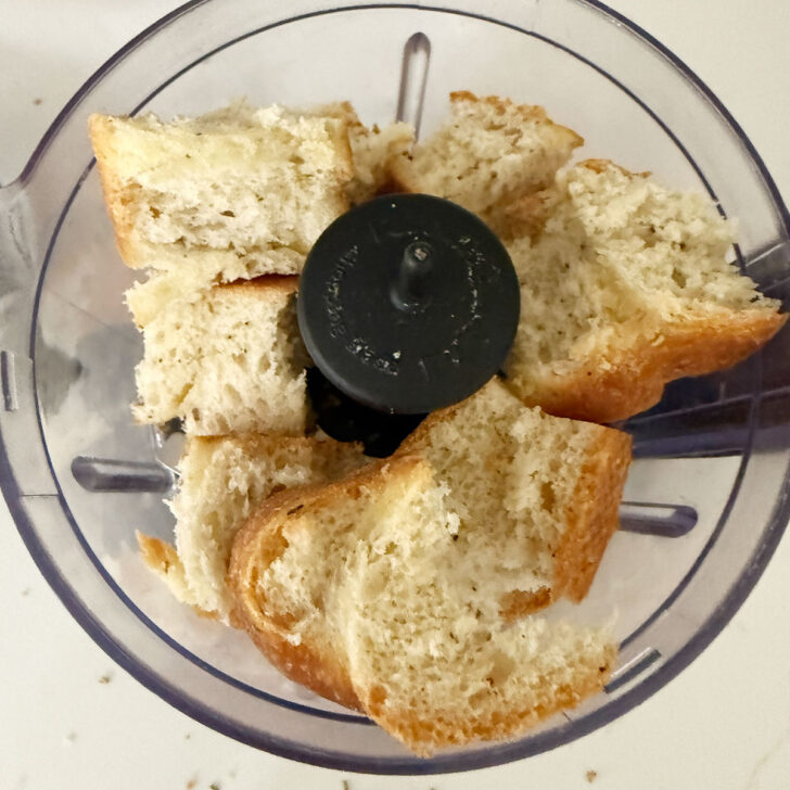 Chunks of bread added to a small food processor.