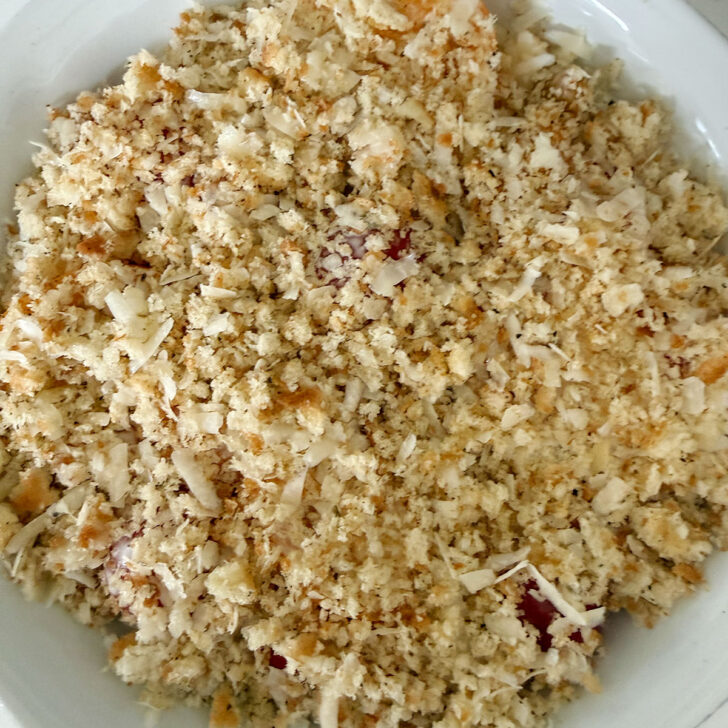 Fresh breadcrumb mixture scattered over the top of the tomatoes before baking.