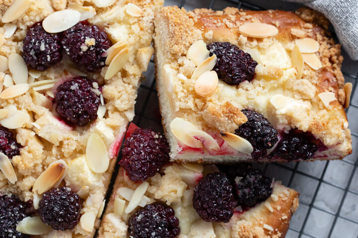 Blackberry apple kuchen sliced on a wire rack.