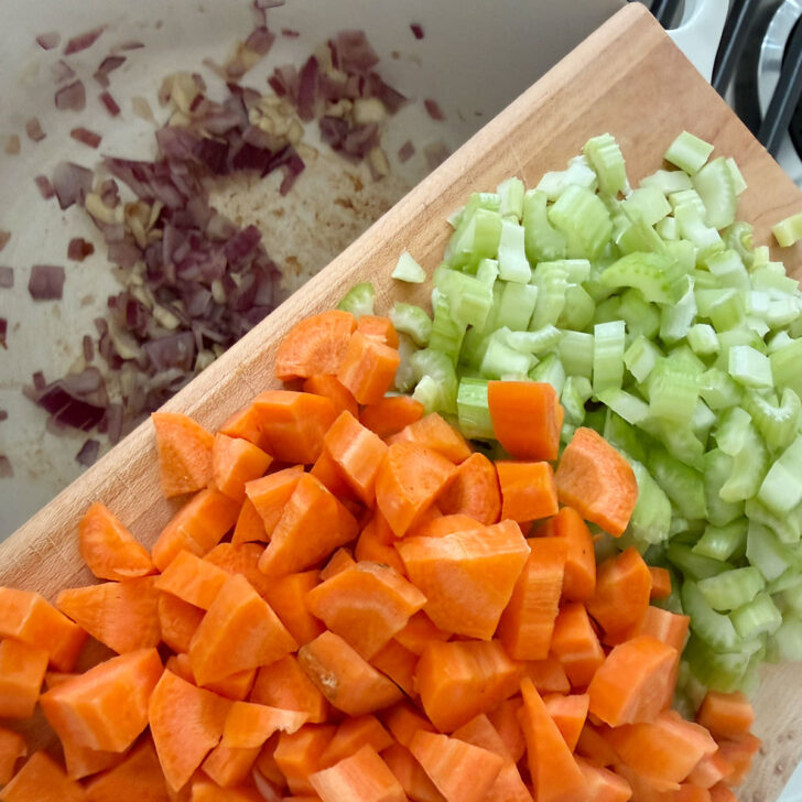 Adding celery and carrots to the onion and garlic.