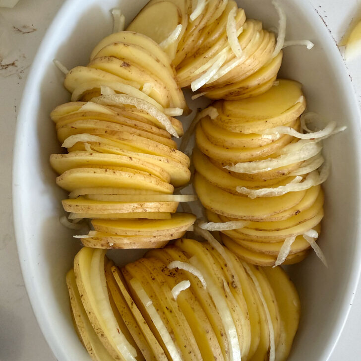 Onion slices tucked in between the potato slices.