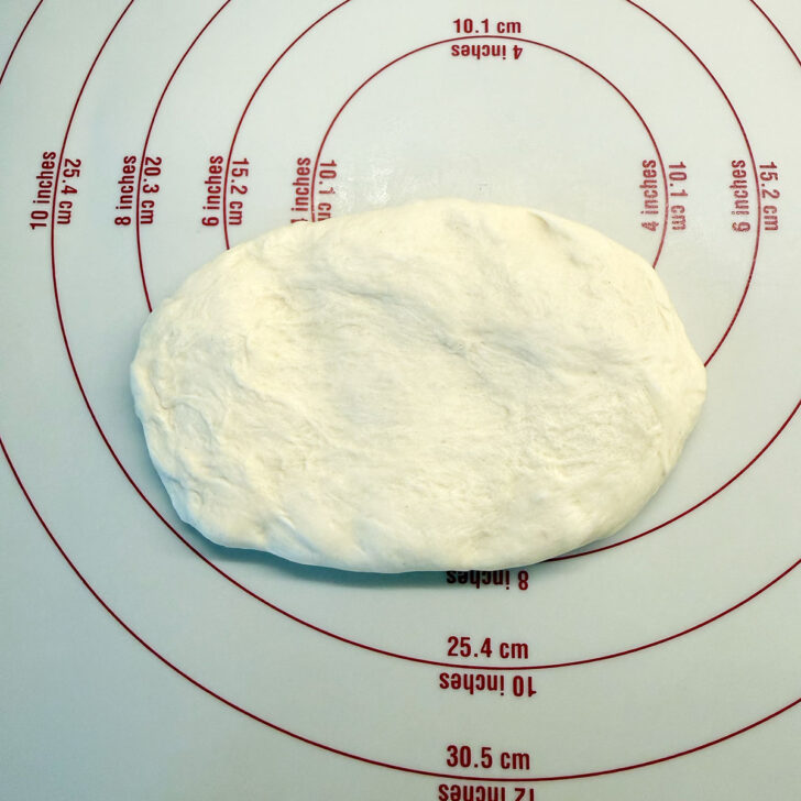 Dough ball pressed into an oval.