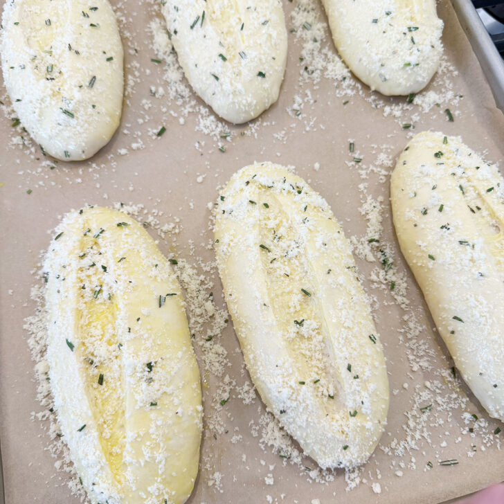 Shaped buns slashed and coated in rosemary and Parmesan.