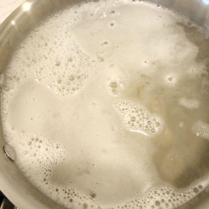 Gnocchi added to a pot of boiling water.