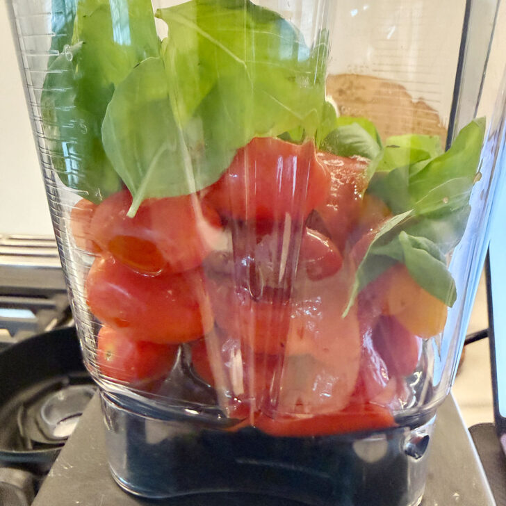 Cherry tomato sauce ingredients in a blender before blending