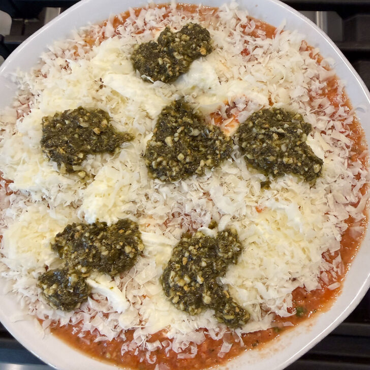 Assembled tomato and pesto baked gnocchi before baking.