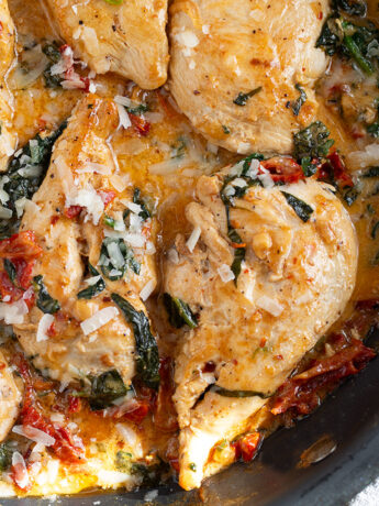 Creamy sun-dried tomato chicken in a skillet.
