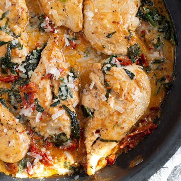 Creamy sun-dried tomato chicken in a skillet.