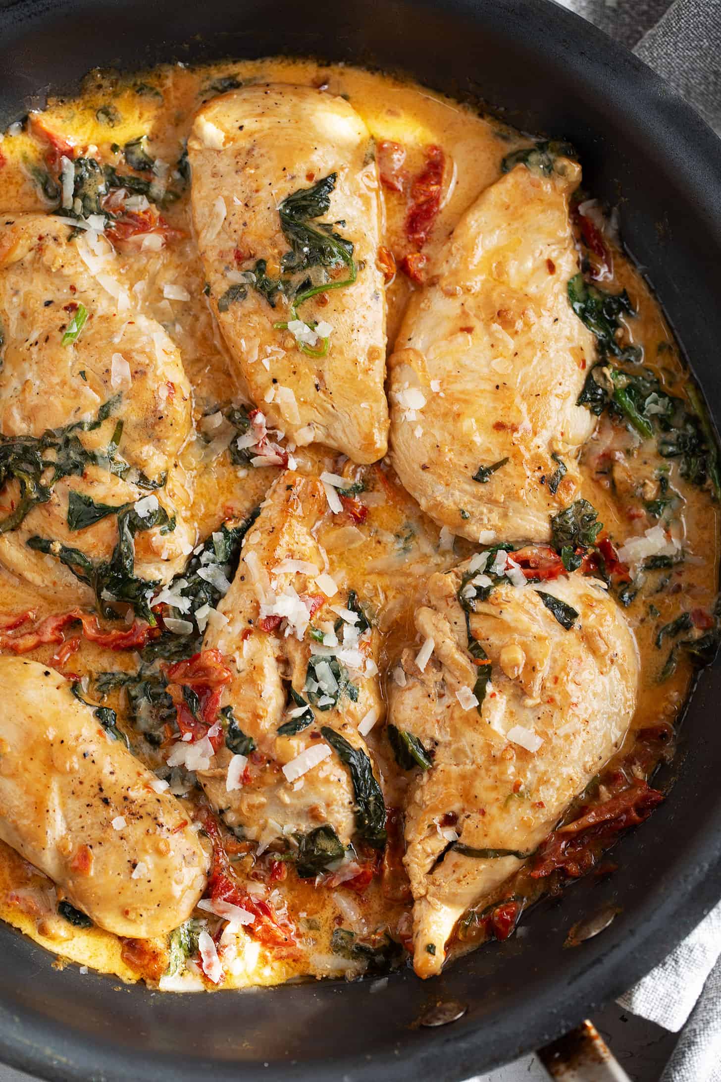 Creamy sun-dried tomato chicken in a skillet.