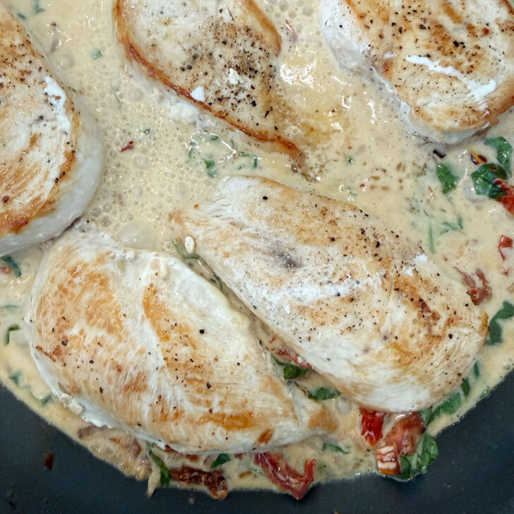 Chicken returned to the skillet with the sauce.